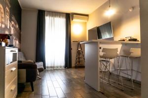 a living room with a kitchen with a table and a bar at Aparthotel Meneghino in Milan