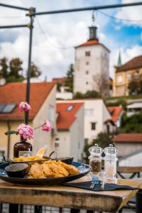 a plate of food on a table with a tower at Timeout Heritage Hotel Zagreb in Zagreb