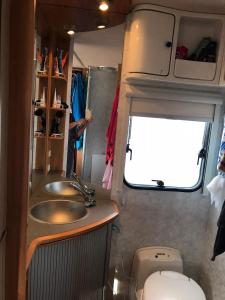 a bathroom with a sink and a toilet in an rv at Husvagn i Hundfjället Sälen in Sälen