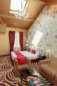 a hotel room with a bed and a stone wall at Hotel Du Beaumont in Paris