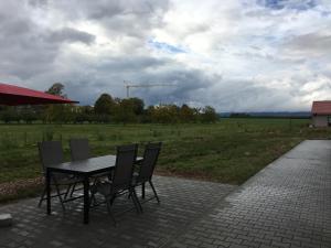 a table and chairs on a patio with a field at Monteurwohnung 1 in Ingelheim am Rhein