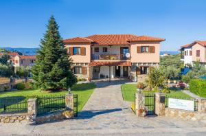 a villa with a gate in front of a house at Xalonia Seaview in Ayios Nikolaos Sithonia