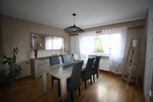 a dining room with a table and chairs at Villa Faby, Jacuzzy Sauna privatif in Saint-Maurice