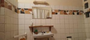 a bathroom with a sink and a mirror at Campement Sindéye in Abémé