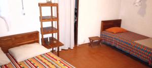 a small room with a bed and a ladder at Campement Sindéye in Abémé