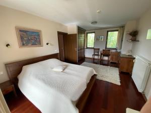 a bedroom with a bed and a dining room at Ski & Spa Chalet Bansko in Bansko