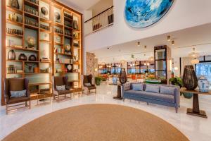 a lobby of a store with a blue couch and chairs at Hotel Fariones in Puerto del Carmen