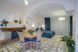 a living room with a table and a couch at Le Querce Resort Sea Thermae & Spa in Ischia