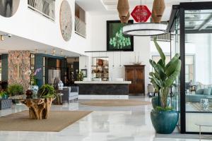 a store lobby with a potted plant and a table at Hotel Fariones in Puerto del Carmen +37 photos