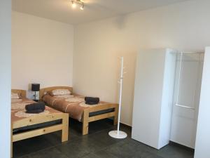 a bedroom with two beds and a lamp in it at Monteurwohnung 2 in Ingelheim am Rhein