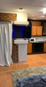 a kitchen with white curtains and a counter in a room at Made Stays in Johannesburg