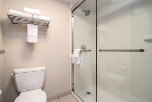 a bathroom with a toilet and a shower with towels at Holiday Inn Express Spokane-Downtown, an IHG Hotel in Spokane