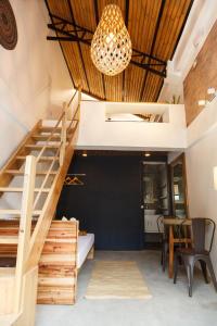 a staircase in a room with a table and a chandelier at SANSE Boutique Hotel in El Nido