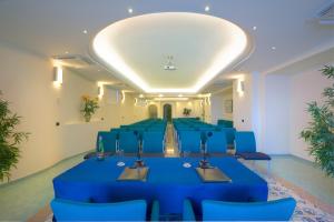 a conference room with a blue table and chairs at Le Querce Resort Sea Thermae & Spa in Ischia