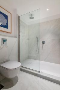 a bathroom with a glass shower and a toilet at Hotel Fariones in Puerto del Carmen