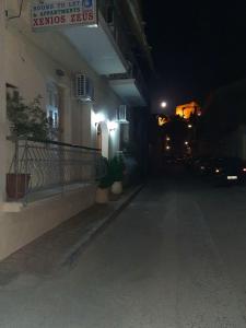 una calle vacía por la noche con un edificio en Apartments Xenios Zeus 1 en Koroni