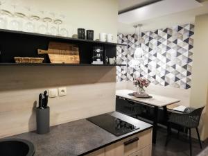 a kitchen with a counter and a table with a table sidx sidx at Fajn Apartment in Šempeter v Savinjski Dolini