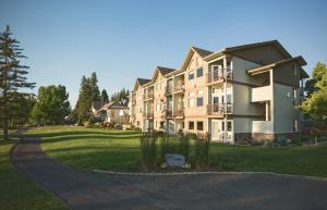 a large apartment building with a driveway at Meadow Lake Resort & Condos in Columbia Falls