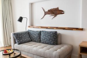 a living room with a couch and a fish on the wall at Hotel Fariones in Puerto del Carmen