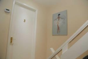 a staircase with a picture of a woman on the wall at Budget 4-Bedrooms In Thamesmead in London