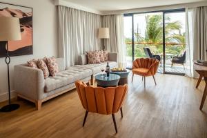 a living room with a couch and a table and chairs at Hotel Fariones in Puerto del Carmen