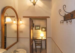 a bathroom with a sink and a mirror and a table at Due Borghi Guest House in Pisa +73 photos