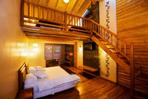 a bedroom with a bed and a wooden staircase at Hosteria Cabañas Del Lago in Otavalo