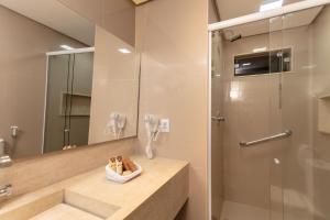 a bathroom with a sink, toilet and mirror at Pratagy Acqua Park Beach All Inclusive Resort - Wyndham in Maceió