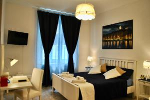 1 dormitorio con cama, mesa y escritorio en B&B Casa TORET, en Turín
