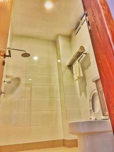 a bathroom with a shower and a toilet at Harmony Valley Retreat in Bukit Tinggi