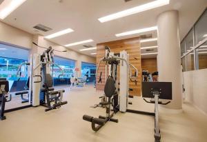 a gym with several tread machines in a room at Flat Hotel Fusion com Varanda & Garagem A219 in Brasilia