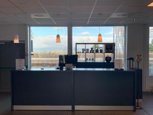 un comptoir dans un bureau avec une grande fenêtre dans l'établissement P-Hotels Brattøra, à Trondheim