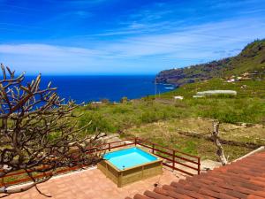 a swimming pool on a hill next to the ocean at Rincón del Mar , Espacio Natural in La Orotava