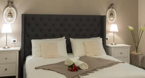 - une chambre avec un grand lit et une tête de lit noire dans l'établissement Residenza Conca Verde B&B la Suite, à Rogolo