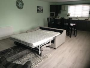 a bed in a room with a table and a kitchen at 1 Slieve Gullion View Killeavy Newry in Newry