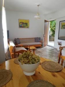 a table with a bowl of grapes on top of it at Perigiali beach apartment - 2 free bikes in Periyiálion