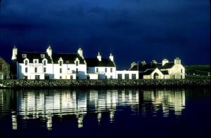 a row of houses on the shore of a body of water at Ayre Hotel & Ayre Apartments in Kirkwall
