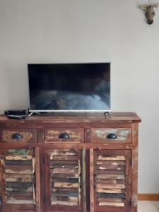 a wooden dresser with a television on top of it at Ferienhaus Hunolstein in Morbach