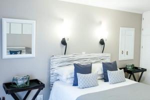 a bedroom with a bed with blue and white pillows at Be Blessed Self-Catering in Bethlehem