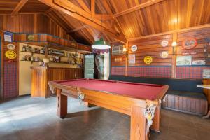a pool table in a room with wooden walls at Wood House in Itaipava +30 photos