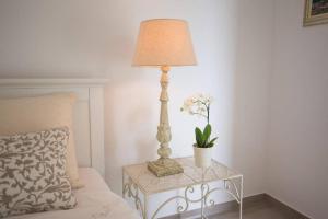 a lamp on a table next to a bed at Villa Bella with pool in Novalja