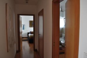 a hallway with two doors leading to a bedroom at Casa do Passadiço in Macieira de Sarnes