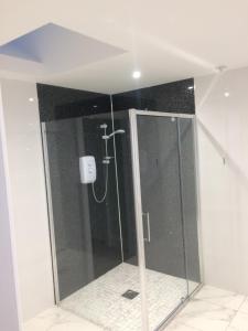 a shower with a glass door in a bathroom at 1 Slieve Gullion View Killeavy Newry in Newry +4 photos