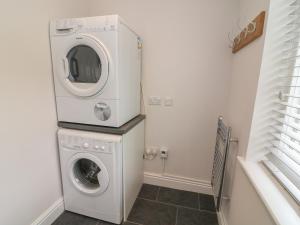 a washer and dryer in a small laundry room at Beck View in Kendal