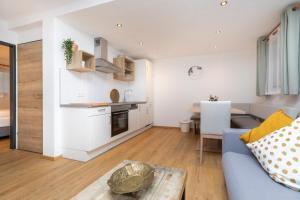 a living room with a couch and a table at Souterrain Apartment Flachau in Flachau