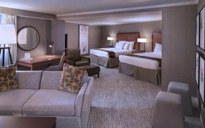 a hotel room with two beds and a couch at Eaglewood Resort & Spa in Itasca