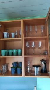 a cabinet filled with lots of dishes and glasses at Central MaxiStay in Rakvere