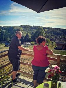 a man and a woman looking at train tracks at carazen , caravane chauffée in Saint-Sylvain-Bellegarde