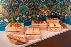 a table with different types of bread and pastries at The Originals Boutique, Parc Hôtel, Orléans Sud in La Chapelle-Saint-Mesmin