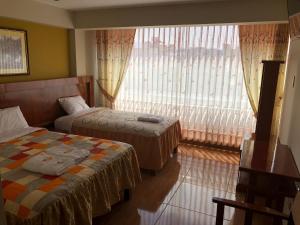 Postel nebo postele na pokoji v ubytování Sumaq Hotel Tacna
